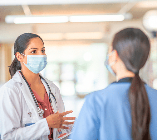 doctor talking to nurse in hospital